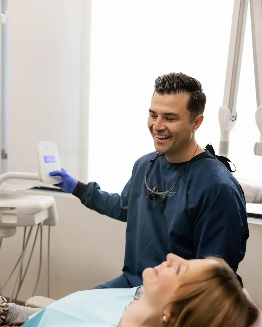 Dr. Strater Crowfoot sharing a laugh with a patient in the treatment room